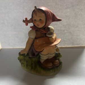 Charming Figurine with Red and Brown Accents